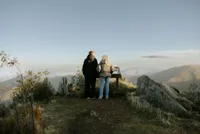 Two people reading content from an ICNF interpretive display, Floema Nature model, in Serra da Estrela.
