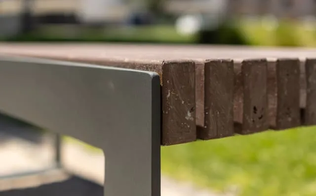 Detalhe de um banco urbano moderno sem encosto, fabricado em plástico reciclado.
