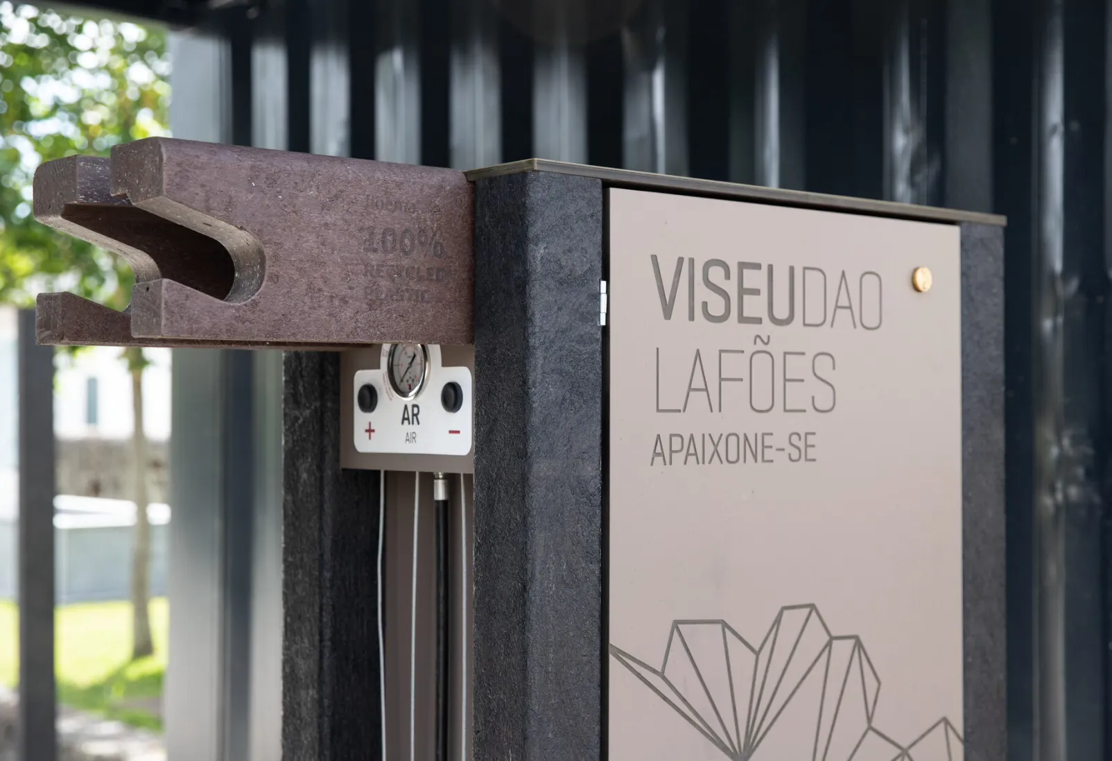 Detail of support and air pump for customised Floema high-tech bike station with black recycled plastic and HPL+ structure.