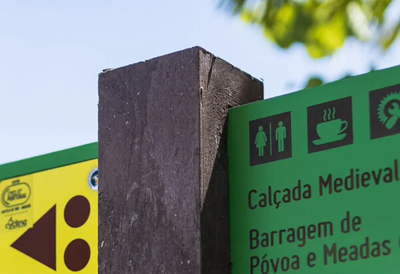 Detail of Angle directional sign in HPL+ embedded in brown recycled plastic post.