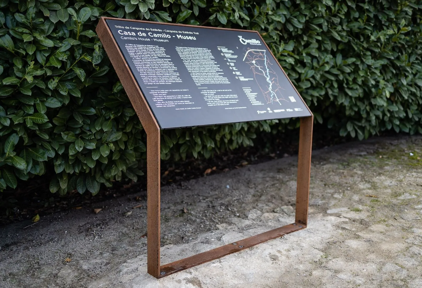 Mesa interpretativa resistente à corrosão para espaços públicos, com estrutura em aço resistente às intempéries e painel de sinalização HPL+.